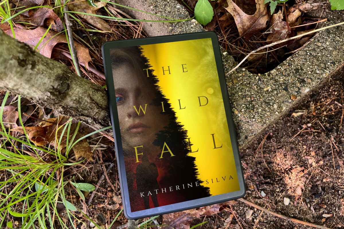 The Wild Fall by Katherine Silva book photo by Erica Robyn Reads of yellow book out in the woods