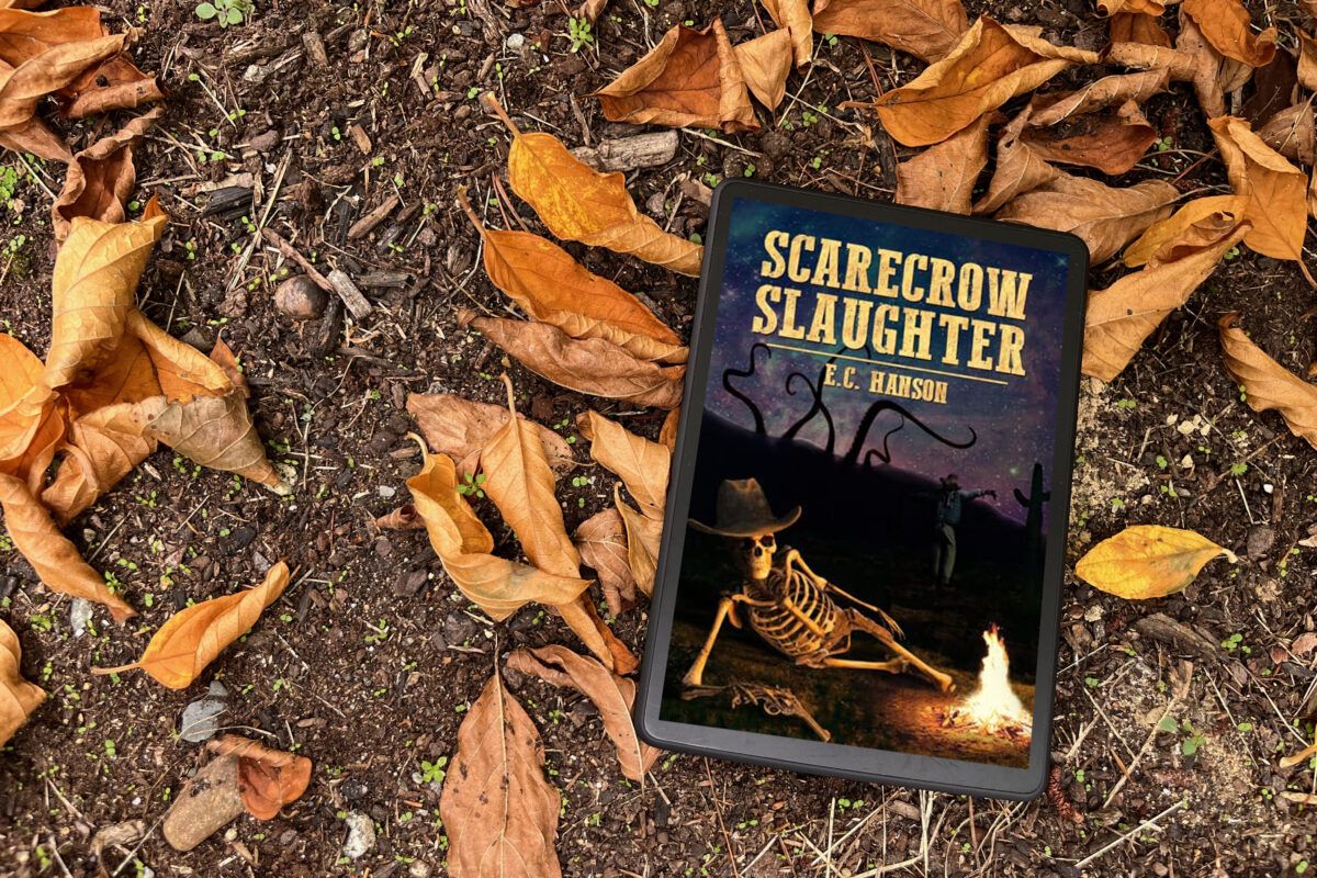 Scarecrow Slaughter by E.C. Hanson | Book Cover features a skeleton wearing a hat sprawled out by a fire
